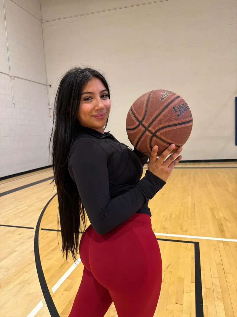 Alessandra Cruz on a basketball court in athletic wear