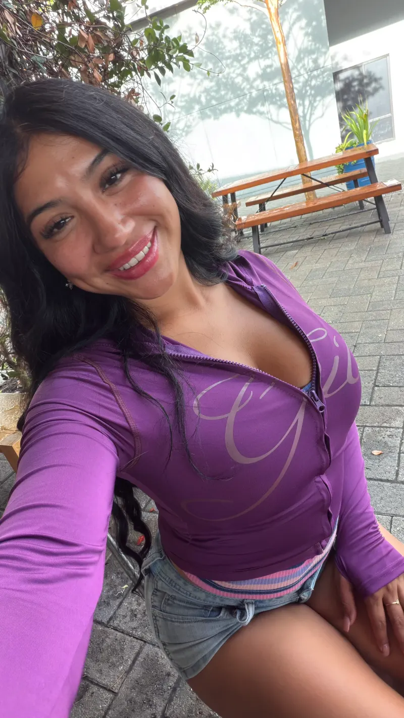 Alessandra Cruz smiling in a purple jacket